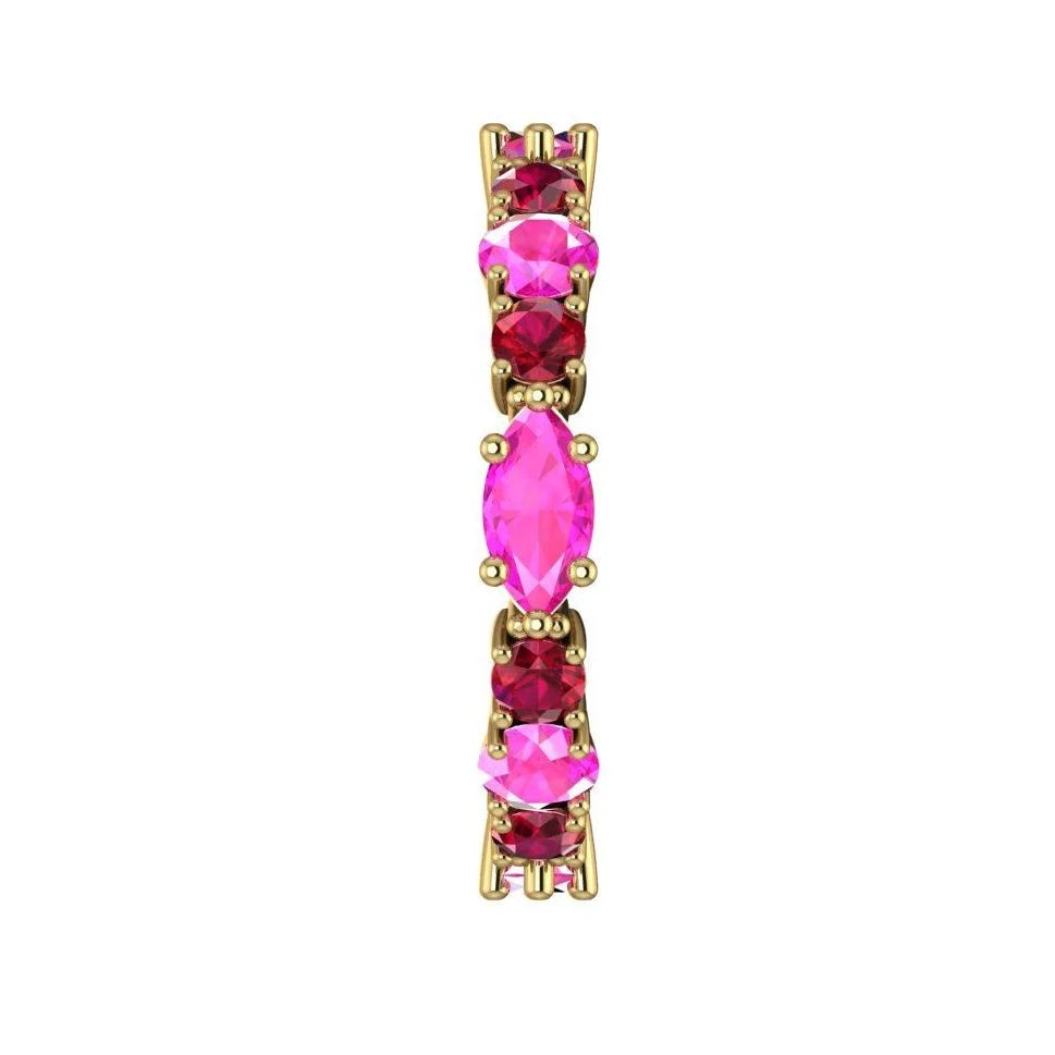Macro detail of the Fire ring showcasing the vibrant red rubies and pink sapphires in a polished yellow gold setting.
