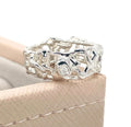 Origin Honeycomb Ring in sterling silver with a brilliant-cut diamond, shown on a beige jewellery box