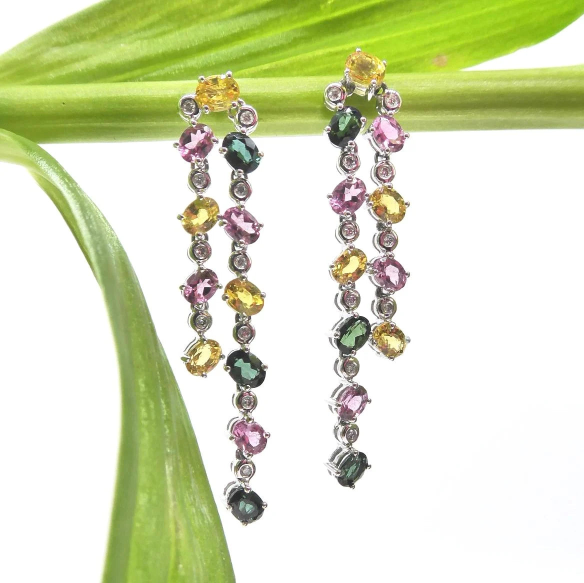 A lifestyle view of the double-drop earrings, highlighting the sparkle of the diamonds and gemstones.