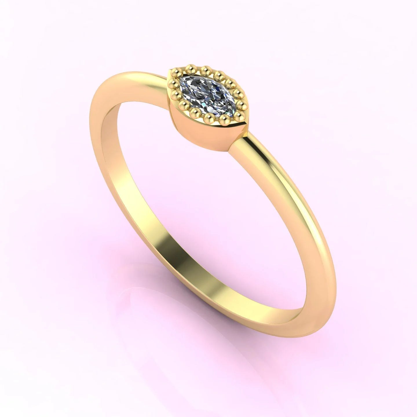 Angled view of a dainty marquise diamond ring with a horizontal East-West setting in a polished yellow gold band.
