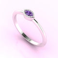 Three-quarter angled view of the dainty violet sapphire ring highlighting the modern horizontal setting and tapered marquise cut.
