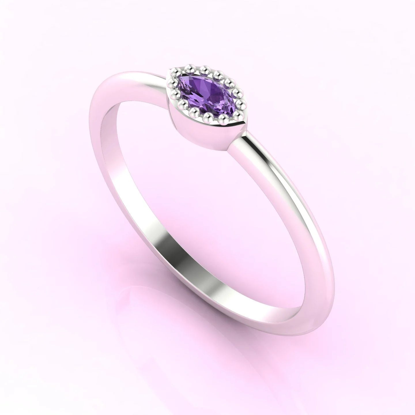Three-quarter angled view of the dainty violet sapphire ring highlighting the modern horizontal setting and tapered marquise cut.