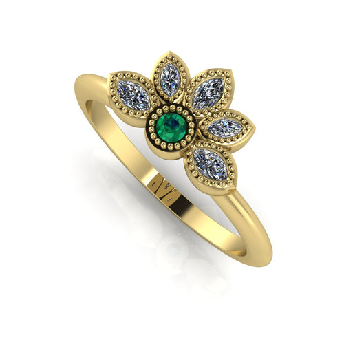 Angled view of an emerald and marquise diamond cluster ring in 18ct yellow gold with textured beaded details.