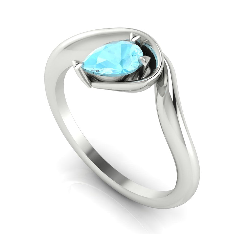 Enchanted pear aquamarine engagement ring in white gold, three-quarter angle view showing vivid aqua stone nestled in wrapped asymmetric setting