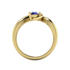 Enchanted pear blue sapphire ring in yellow gold, dramatic side view showing the full asymmetric sweeping band and deep blue sapphire setting