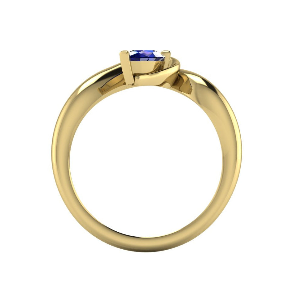 Enchanted pear blue sapphire ring in yellow gold, dramatic side view showing the full asymmetric sweeping band and deep blue sapphire setting