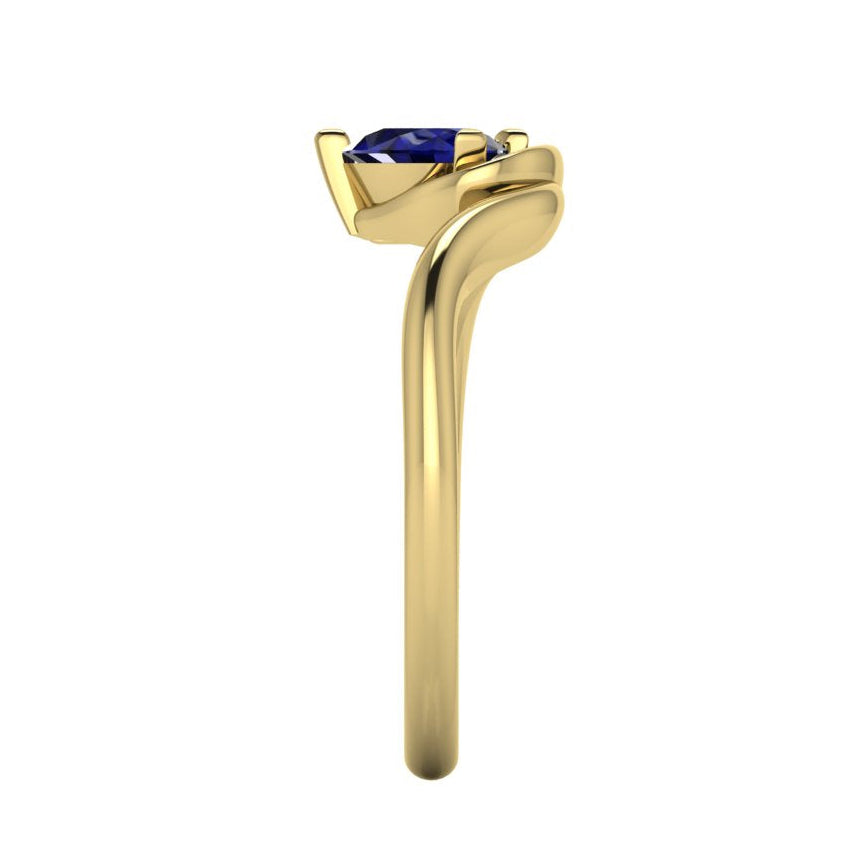 Enchanted pear blue sapphire ring in yellow gold, side profile view showing sculptural asymmetric band height and elegant sweeping silhouette