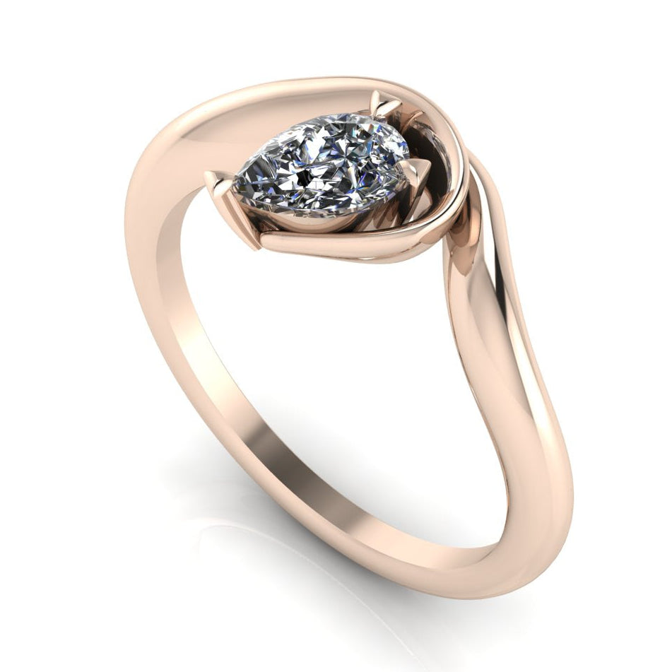 Enchanted pear diamond engagement ring in rose gold, three-quarter angle view showing brilliant stone nestled in wrapped asymmetric setting