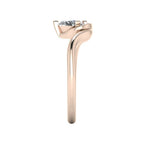 Enchanted pear diamond ring in rose gold, side profile view showing dramatic sculptural asymmetric height and sweeping band silhouette