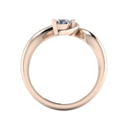 Enchanted pear diamond ring in rose gold, through-finger view showing clean interior band and low-set asymmetric profile