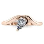 Enchanted pear shaped diamond ring in rose gold, overhead top-down view showing brilliant stone and fluid sweeping band design