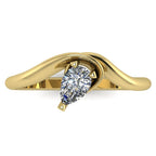 Enchanted pear shaped diamond ring in yellow gold, overhead top-down view showing brilliant stone and fluid sweeping band design