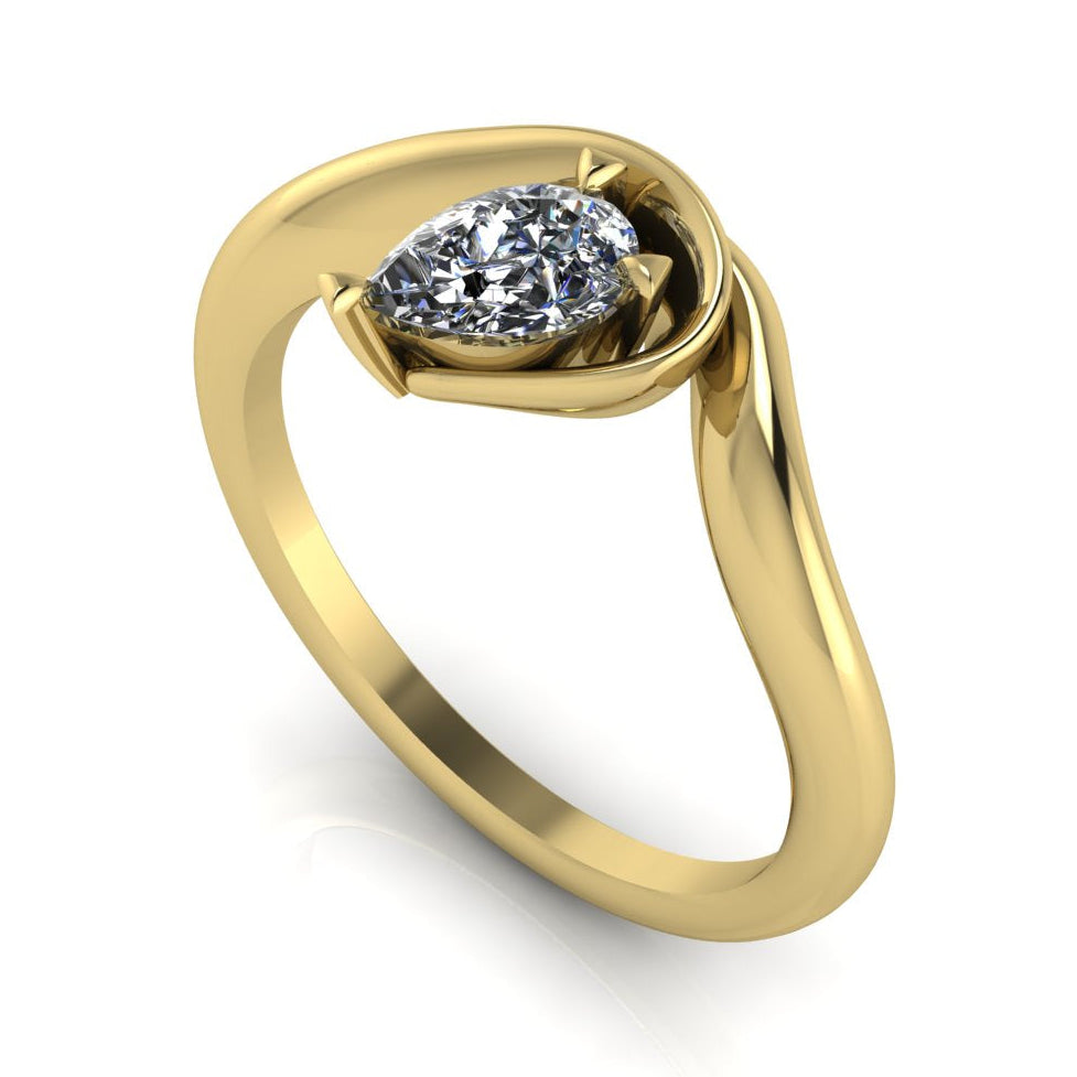 Enchanted lab grown diamond pear engagement ring in yellow gold, three-quarter angle view showing east-west set diamond nestled in asymmetric organic setting
