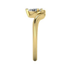 Enchanted pear shaped lab grown diamond ring in yellow gold, overhead top-down view showing brilliant stone and fluid sweeping band design