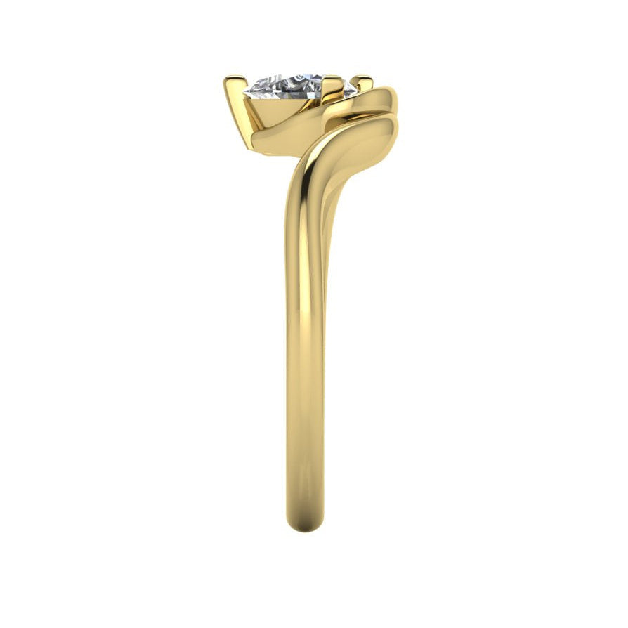 Enchanted pear shaped lab grown diamond ring in yellow gold, overhead top-down view showing brilliant stone and fluid sweeping band design