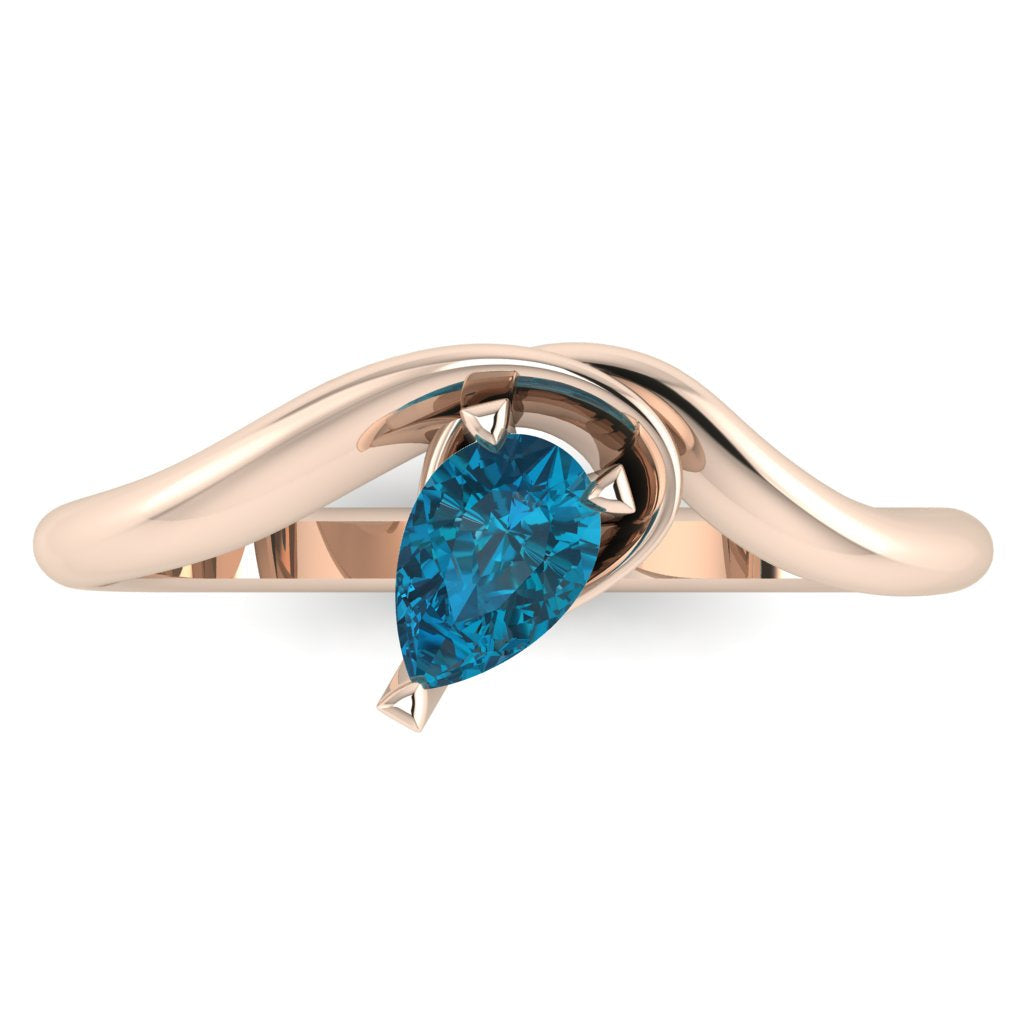 Enchanted pear shaped London Blue Topaz asymmetric solitaire engagement ring in rose gold, front view showing deep ink-blue stone and sculptural sweeping band