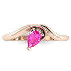 Enchanted pear shaped pink sapphire ring in rose gold, overhead top-down view showing vivid pink stone and fluid sweeping band design