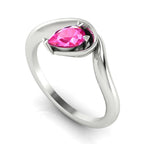 Enchanted pear pink sapphire engagement ring in white gold, three-quarter angle view showing vibrant stone nestled in wrapped asymmetric setting