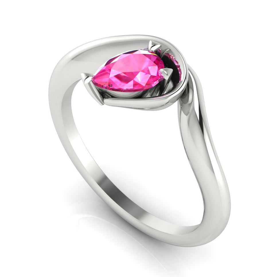 Enchanted pear pink sapphire engagement ring in white gold, three-quarter angle view showing vibrant stone nestled in wrapped asymmetric setting