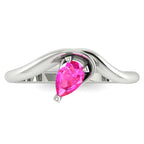 Enchanted pear shaped pink sapphire ring in white gold, overhead top-down view showing vivid pink stone and fluid sweeping band design