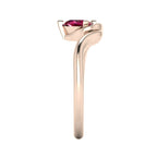 Enchanted pear ruby ring in rose gold, dramatic side profile showing extraordinary sculptural height and elegantly curved asymmetric shank