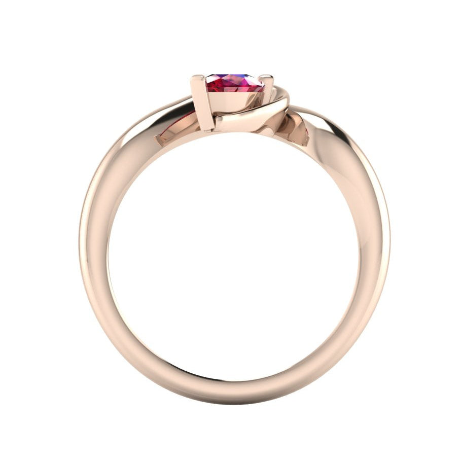 Enchanted pear ruby ring in rose gold, straight-on through-finger view showing clean band interior and low-set asymmetric profile