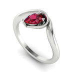 Enchanted pear ruby engagement ring in white gold, three-quarter angle view showing rich red stone nestled in wrapped asymmetric setting