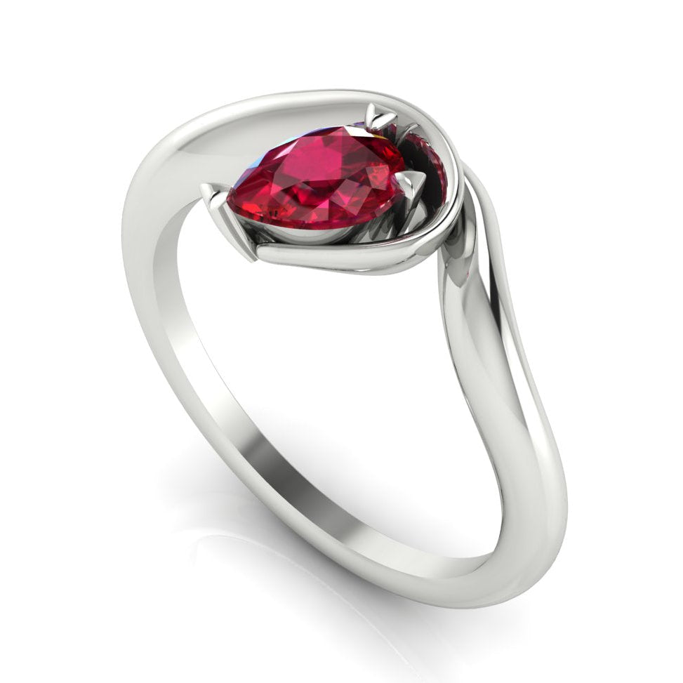 Enchanted pear ruby engagement ring in white gold, three-quarter angle view showing rich red stone nestled in wrapped asymmetric setting