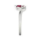 Enchanted pear ruby ring in white gold, side profile view showing dramatic sculptural asymmetric height and elegant sweeping band silhouette
