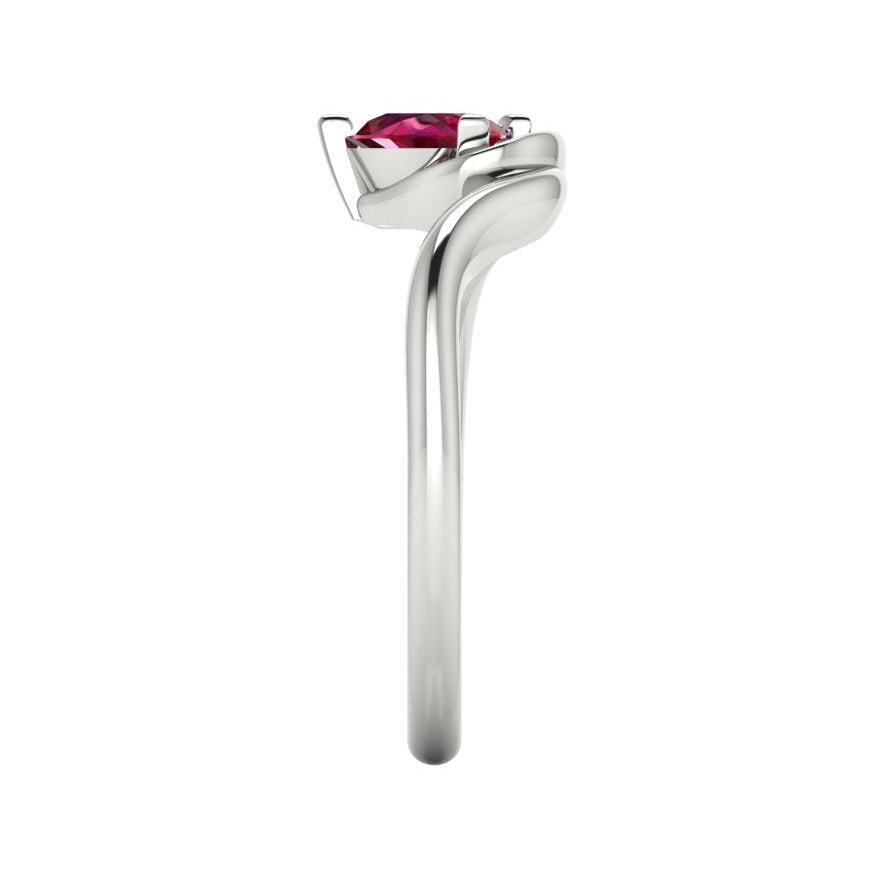Enchanted pear ruby ring in white gold, side profile view showing dramatic sculptural asymmetric height and elegant sweeping band silhouette