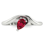 Enchanted pear shaped ruby ring in white gold, overhead top-down view showing vivid red stone and fluid sweeping band design