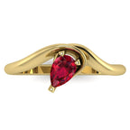 Enchanted pear shaped ruby ring in yellow gold, overhead top-down view showing vivid red stone and fluid asymmetric sweeping band design