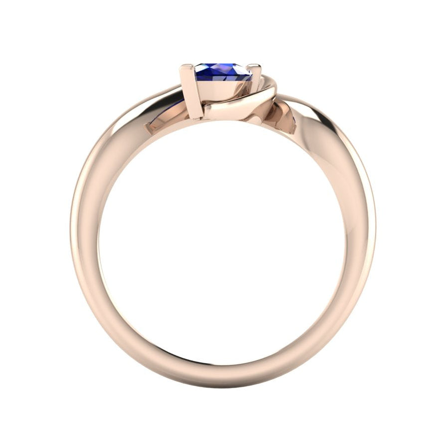 Enchanted pear sapphire ring in rose gold, straight-on through-finger view showing clean band interior and low-set asymmetric profile
