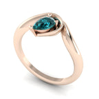 Enchanted teal sapphire pear engagement ring in rose gold, three-quarter angle view showing ocean-hued stone nestled in asymmetric organic setting