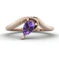 Enchanted pear shaped violet sapphire asymmetric solitaire engagement ring in rose gold, front view showing vivid lavender stone and sculptural sweeping band