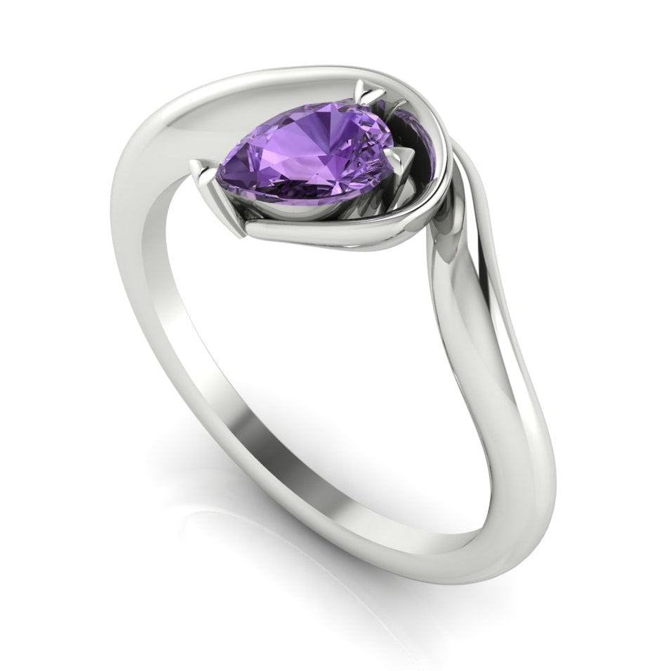 Enchanted pear violet sapphire engagement ring in white gold, three-quarter angle view showing delicate lavender stone nestled in wrapped asymmetric setting
