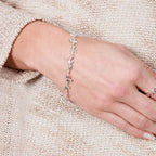 Close-up shot of the Lucy Q fine silver Splat bracelet worn on a wrist, demonstrating the delicate fit and drape.