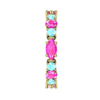 Macro shot showing the contrast between yellow gold, pink sapphire, and blue aquamarine.