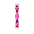 Macro detail of the Fire ring showcasing the vibrant red rubies and pink sapphires in a polished white metal setting.