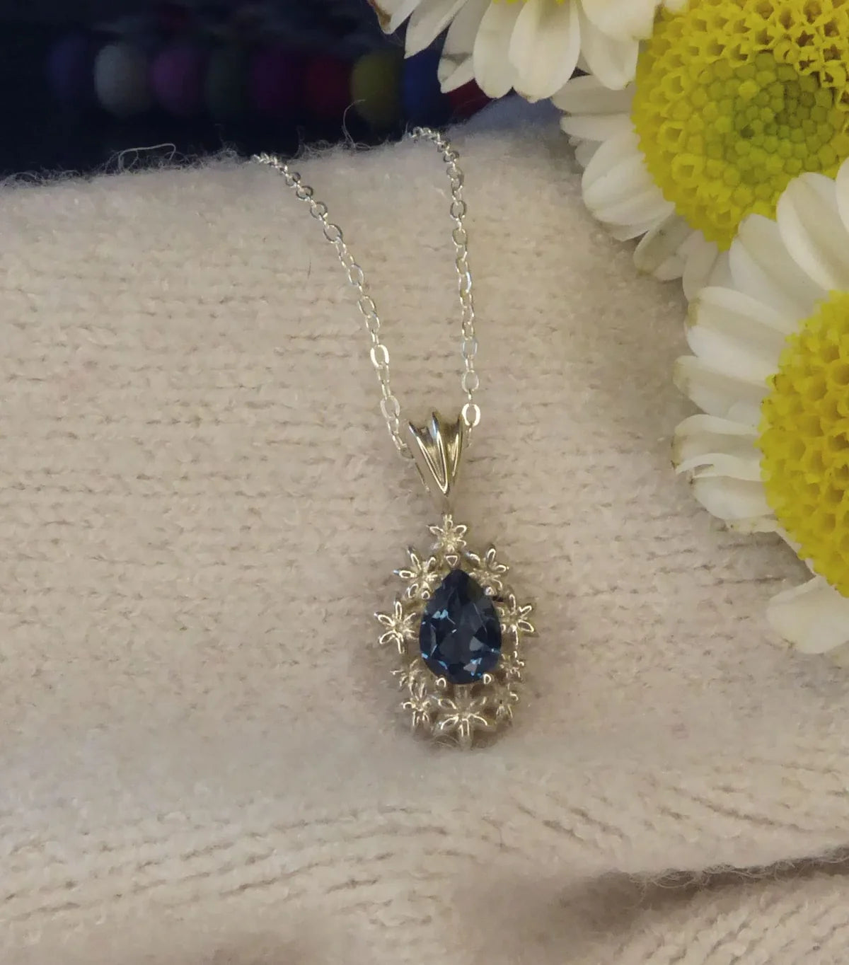 Fleur London Blue Topaz flower pendant in recycled sterling silver with adjustable chain
