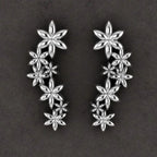 Pair of Fleur cascading flower earrings in recycled sterling silver showing the seven-flower drop design