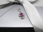 Close-up of pear-shaped pink tourmaline set in the Fleur recycled silver flower pendant