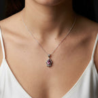 Fleur pink tourmaline pendant necklace in recycled sterling silver with an adjustable 16 to 18 inch chain on model