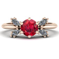 Flutterby ruby butterfly engagement ring front view — round ruby centre with four white marquise diamond wings in recycled 18ct rose gold by Nude Jewellery