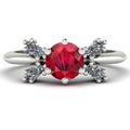 Flutterby ruby butterfly engagement ring front view — symmetrical marquise diamond wing silhouette framing round ruby in white gold by Nude Jewellery