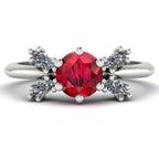 Flutterby ruby butterfly engagement ring front view — symmetrical marquise diamond wing silhouette framing round ruby in white gold by Nude Jewellery