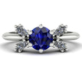 Flutterby blue sapphire butterfly engagement ring front view — blue sapphire centre with four white marquise diamond wings in recycled 18ct white gold by Nude Jewellery