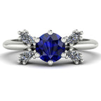 Flutterby blue sapphire butterfly engagement ring front view — blue sapphire centre with four white marquise diamond wings in recycled 18ct white gold by Nude Jewellery