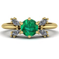 Flutterby emerald butterfly engagement ring front view — round emerald centre with four white marquise diamond wings in recycled 18ct yellow gold by Nude Jewellery
