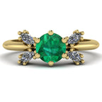 Flutterby emerald butterfly engagement ring front view — round emerald centre with four white marquise diamond wings in recycled 18ct yellow gold by Nude Jewellery